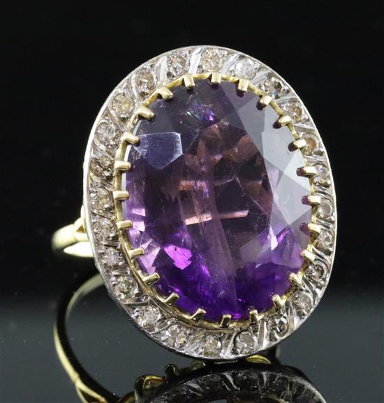 A large gold, amethyst and diamond set oval dress ring, size S.